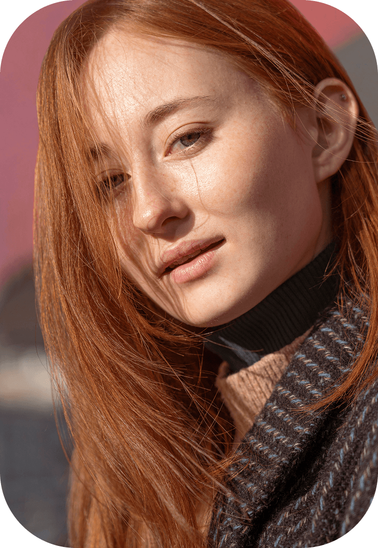 Emma, a young woman with auburn hair in a scarf